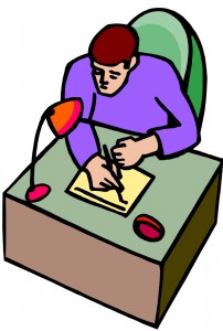 Man writing on pad at desk