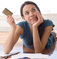 thinking woman holding credit card
