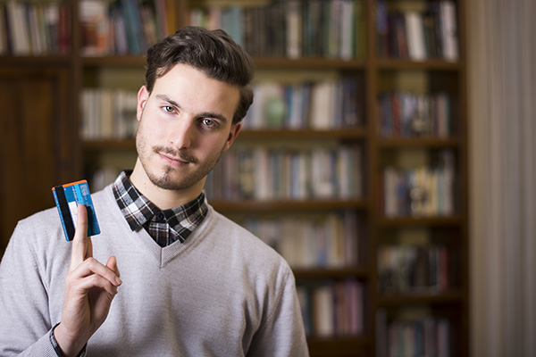young man considering credit card debt consolidation