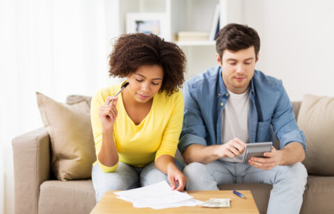 Couple researching DIY debt consolidation