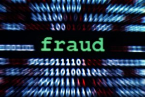 The word fraud surrounded by ones and zeros