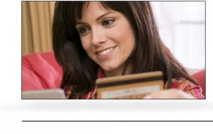 smiling woman holding gold credit card