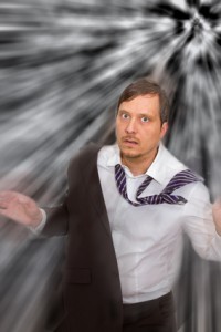 Panicked looking man with tie askew and coat half off