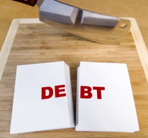 Word Debt cut in half on chopping board