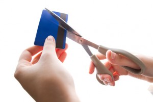 cutting up credit card with scissors