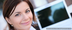 Woman smiling with monitor in the background