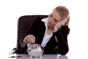woman putting coins in a piggy bank