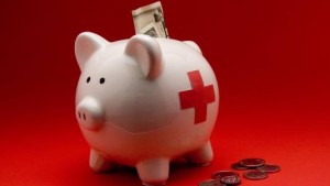 piggy bank with red cross