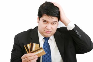 man holding out credit cards
