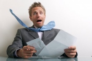 shocked man looking at documents