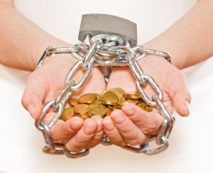 hands chained while holding coins