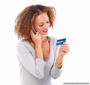 young woman looking at credit card