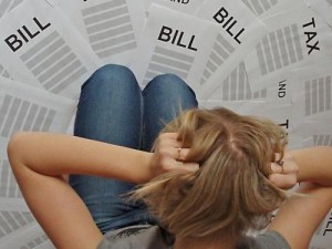 woman looking at a lot of bills