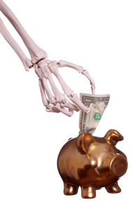 skeleton hand and piggy bank