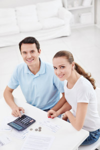 A young couple with money at home