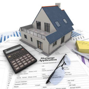 house and calculator on a mortgage application
