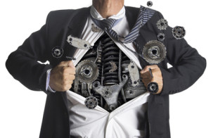 Businessman showing a superhero suit underneath machinery metal gears idea concept, isolated on white background
