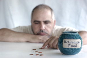 depressed man with coins for retirement fund