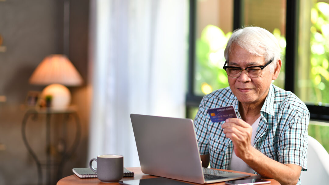 senior man using a credit card