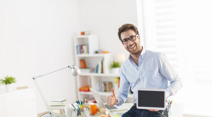 Man holding computer working at home