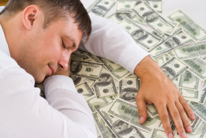 man sleeping on money