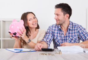 young couple with piggy bank