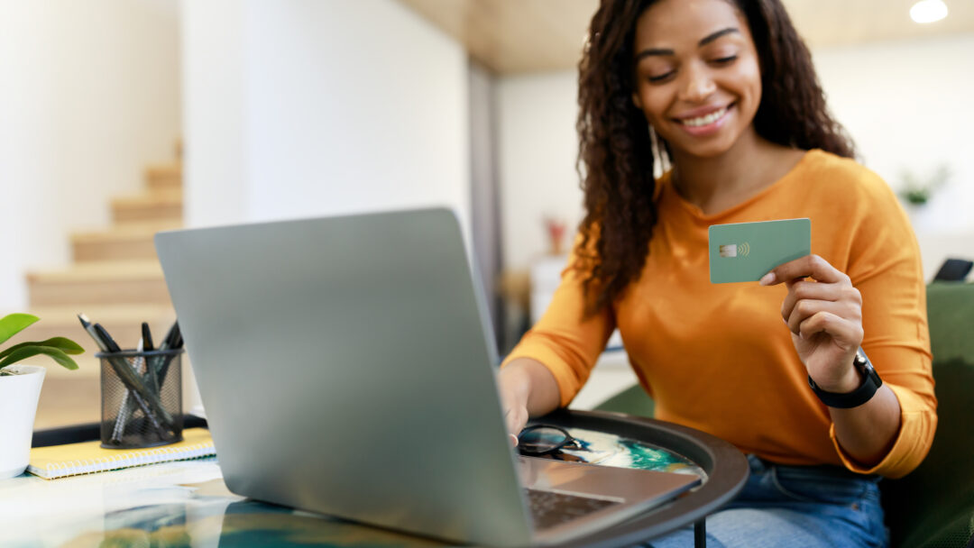 happy woman holding credit card