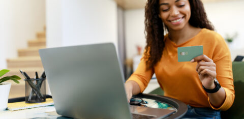 happy woman holding credit card