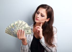 woman looking at money
