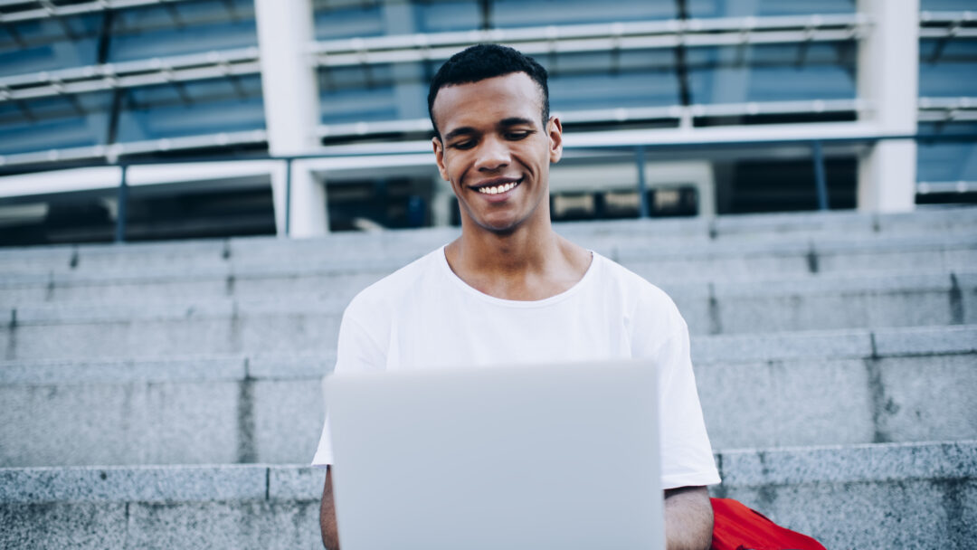guy with laptop sitting on steps