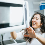 young woman making a microwave mug meal