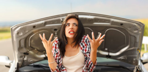 woman frustrated in front of her car