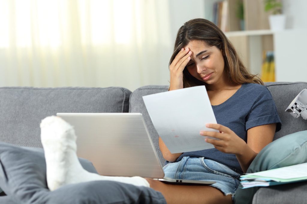 Stressed woman looking at medical bills