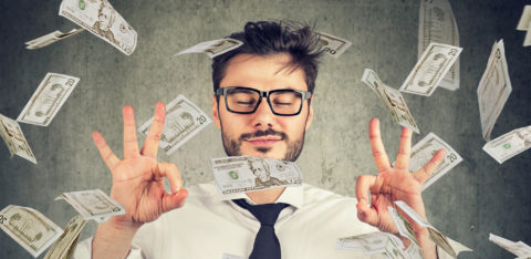 man with a positive financial mindset surrounded by money