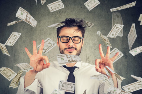 man with a positive financial mindset surrounded by money