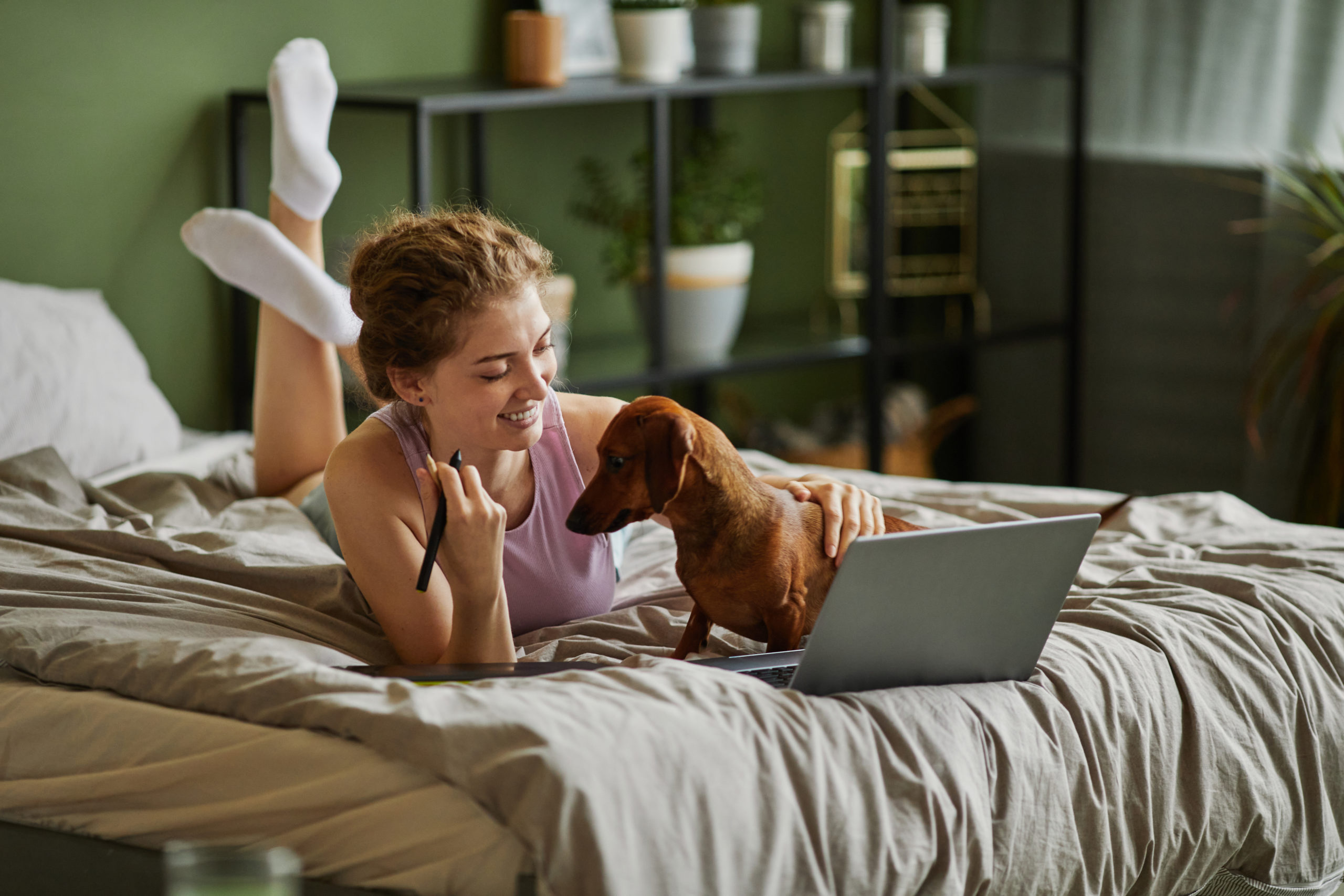 woman on her laptop with her dog
