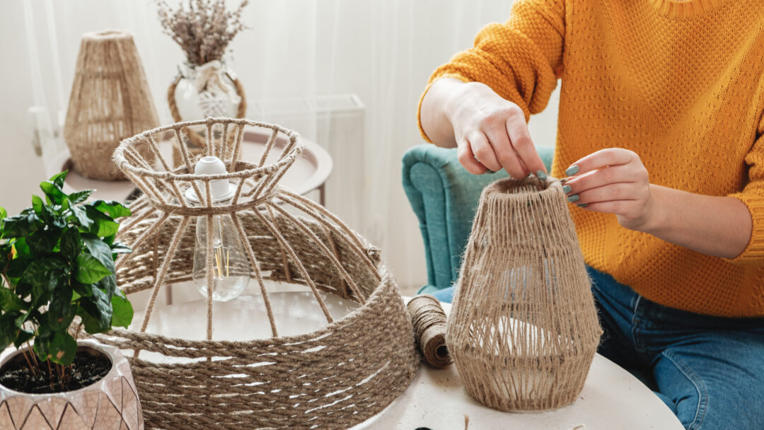 Woman makes handmade diy lamp from jute rope