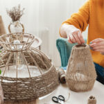 Woman makes handmade diy lamp from jute rope
