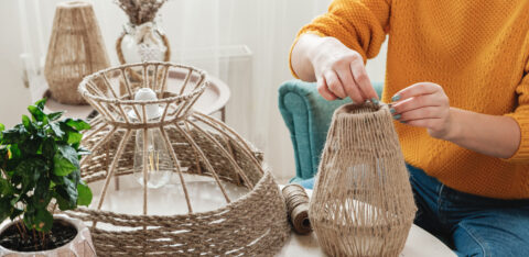 Woman makes handmade diy lamp from jute rope