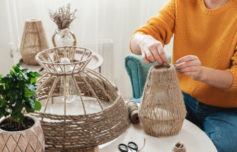 Woman makes handmade diy lamp from jute rope