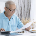 senior man looking at a tax refund