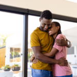 Happy African American Couple Hugging in Living Room