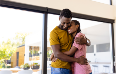 Happy African American Couple Hugging in Living Room