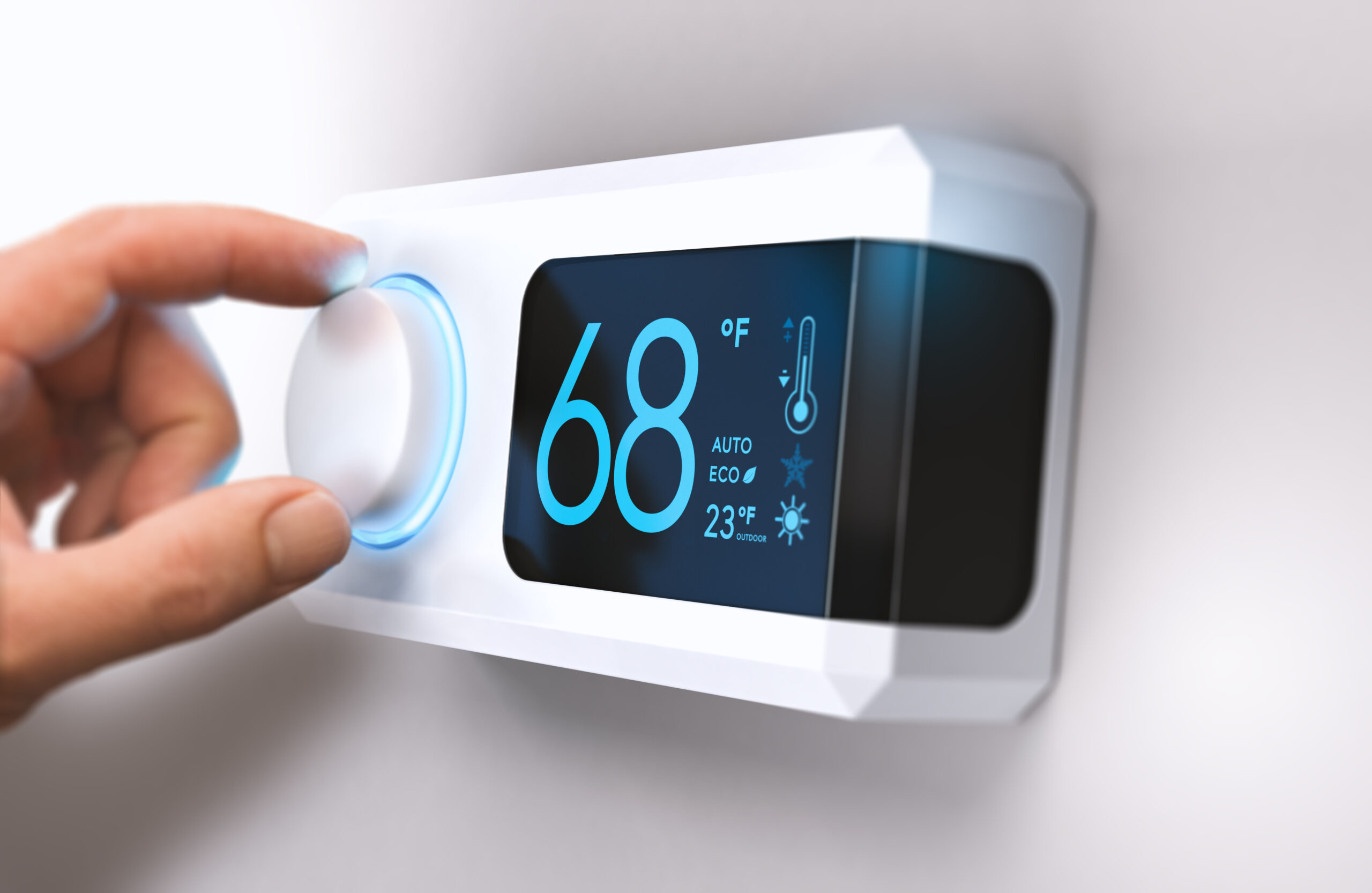 hand turning down temperature for home energy savings