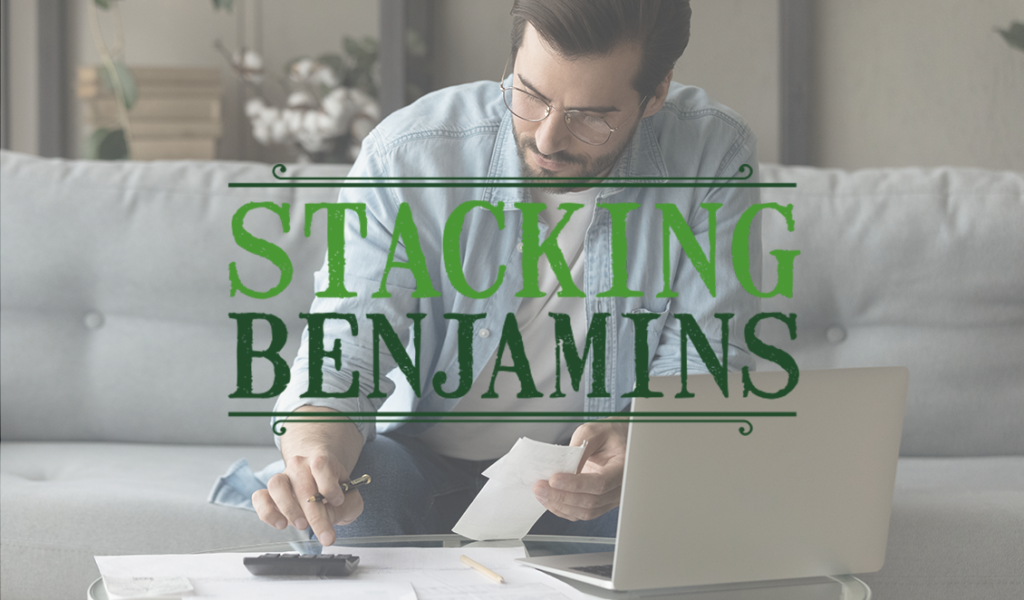 Cover art for the Stacking Benjamins podcast. A picture of a man seated in front of a laptop doing financial calculations.