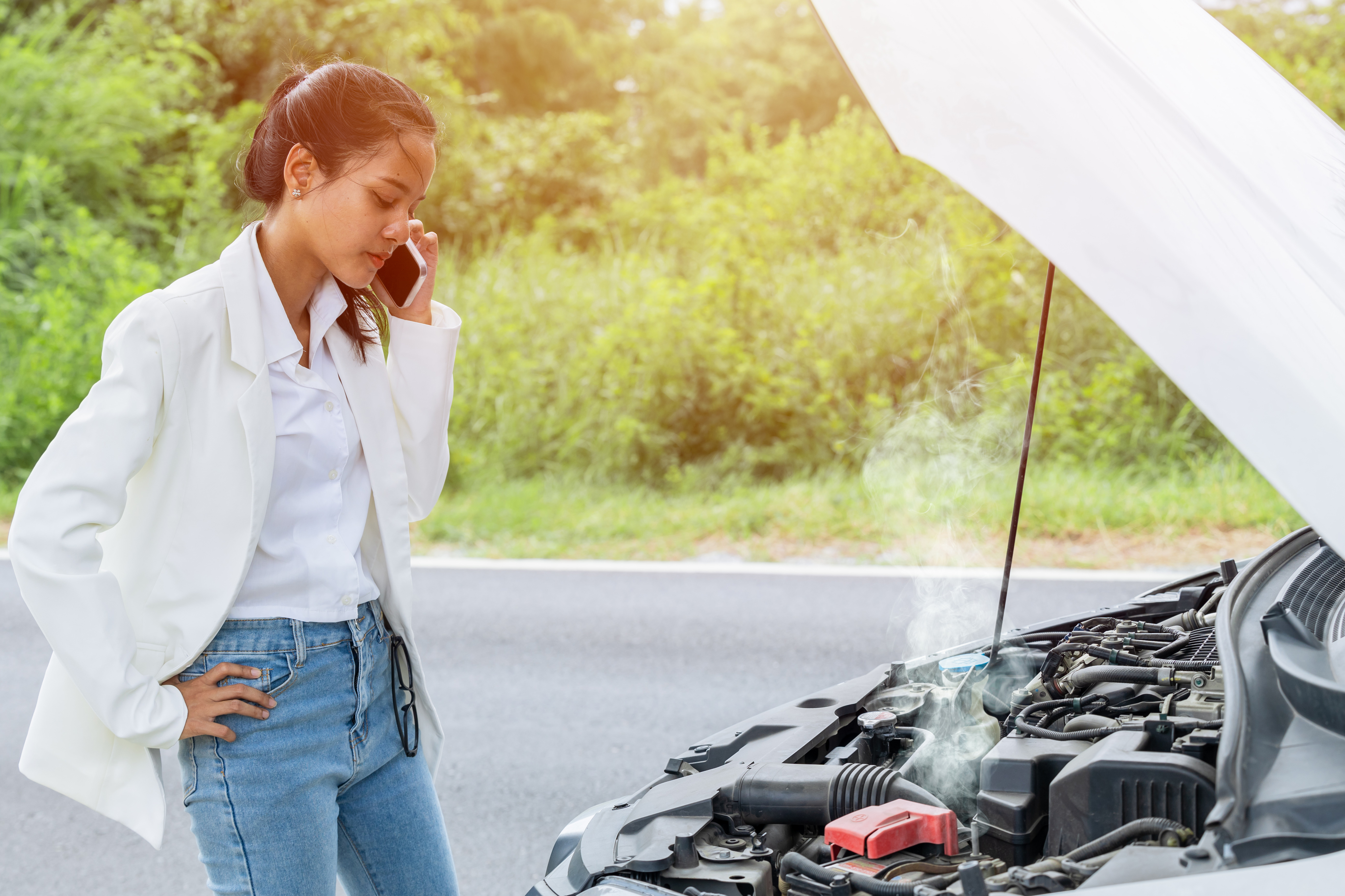 woman stranded on road with car troubles