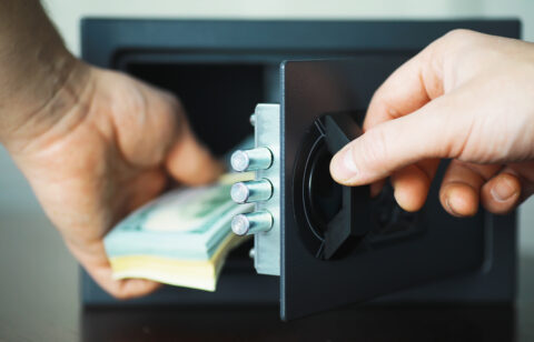 putting money away in a safe