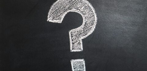 White chalk-drawn question mark on a blackboard background.