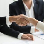 Close-up of a professional handshake between two people in business attire