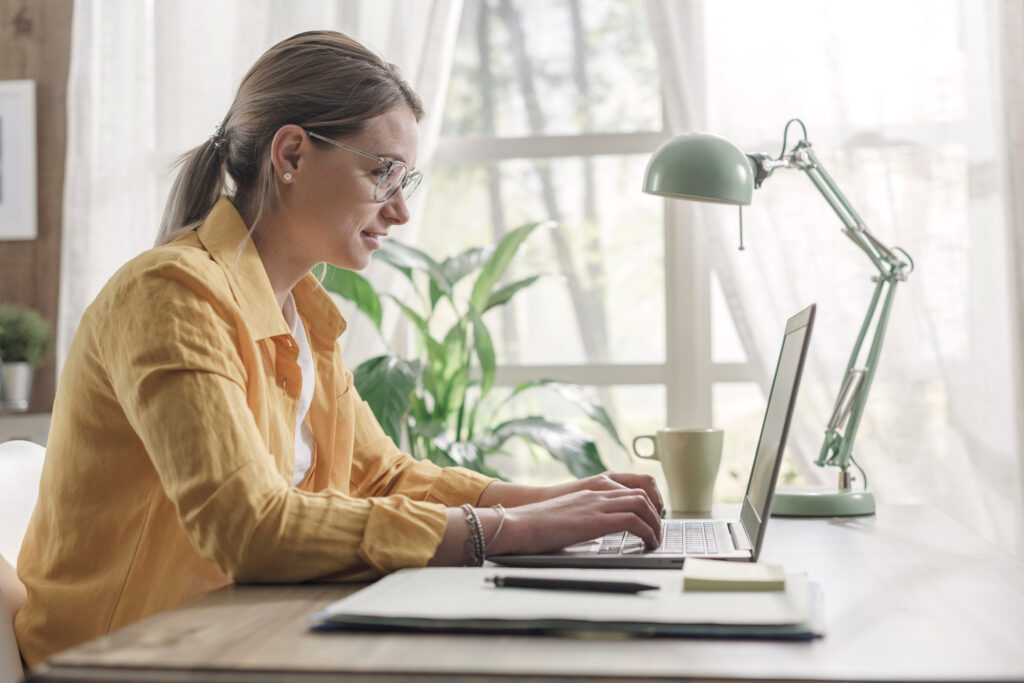Young businesswoman sitting at desk and working from home